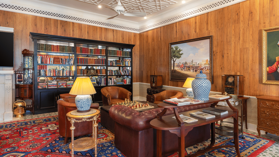 Cosy library lounge featuring plush leather seating and wood-panelled walls at Mayfair Manor, Jungpana.