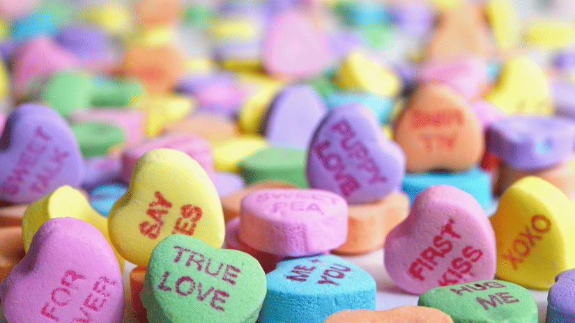 Creative showcasing colorful heart-shaped candies with sweet love messages in a bright and playful arrangement.