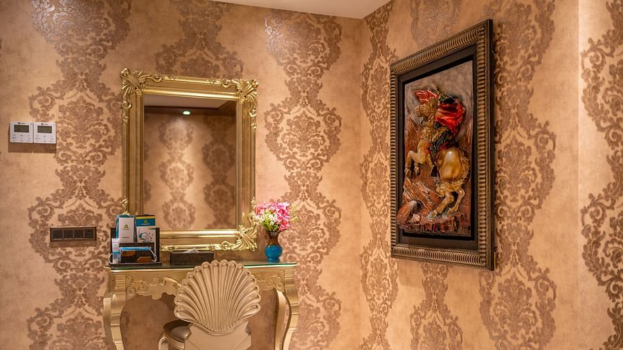 Presidential Suite featuring elegant wallpaper and neatly arranged photo frames at Crescent Spa & Resort, Indore