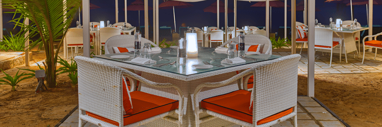 Outdoor tables at Azaya Beach Resort Goa, high on the list of recommended restaurants near Varca Beach.