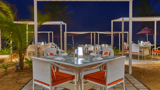 Outdoor tables at Azaya Beach Resort Goa, high on the list of recommended restaurants near Varca Beach.