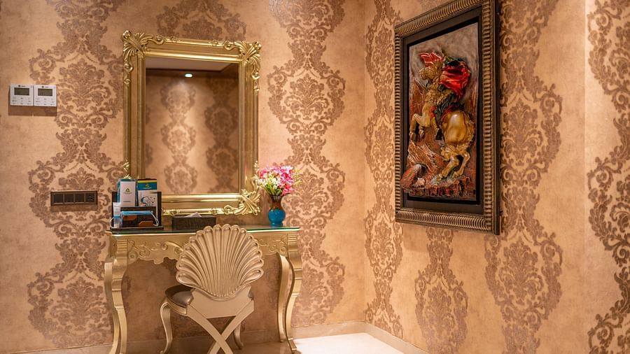 Presidential Suite featuring elegant wallpaper and neatly arranged photo frames at Crescent Spa & Resort, Indore