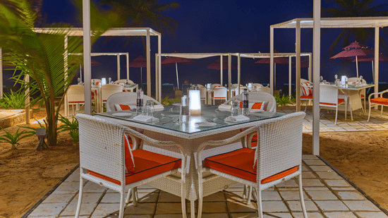 Outdoor tables at Azaya Beach Resort Goa, high on the list of recommended restaurants near Varca Beach.