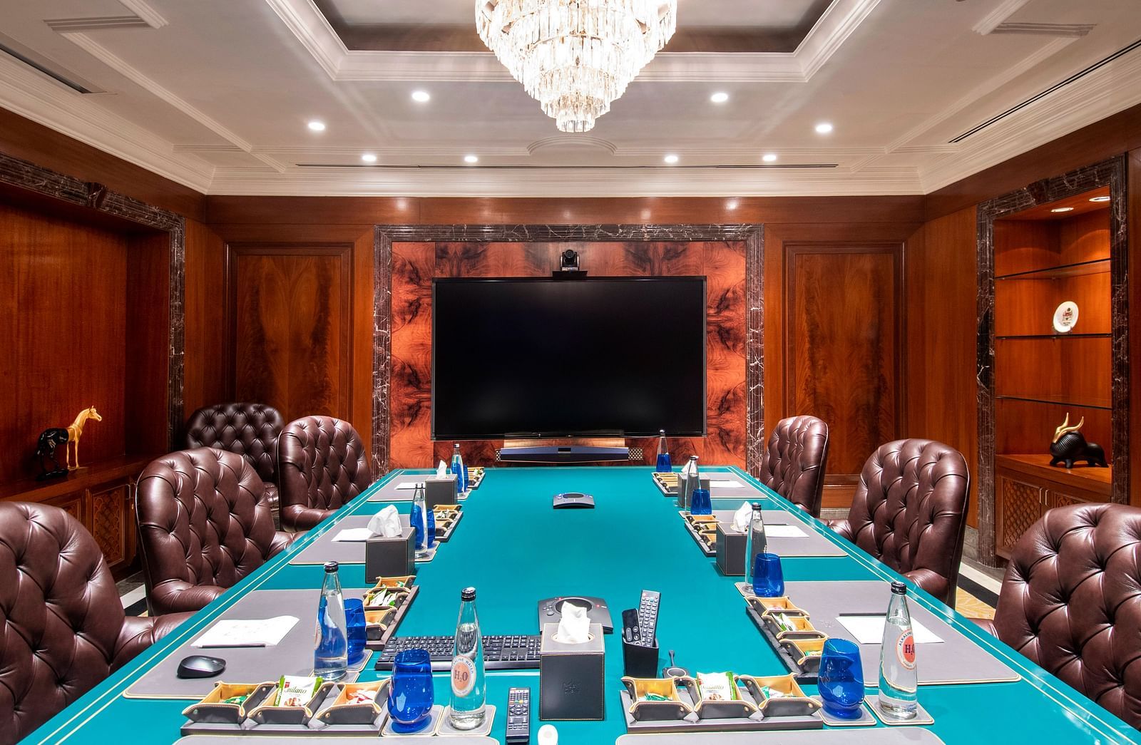 An image of the elegant meeting room with bottles of Alkaline water placed for serving - Claridges Collection