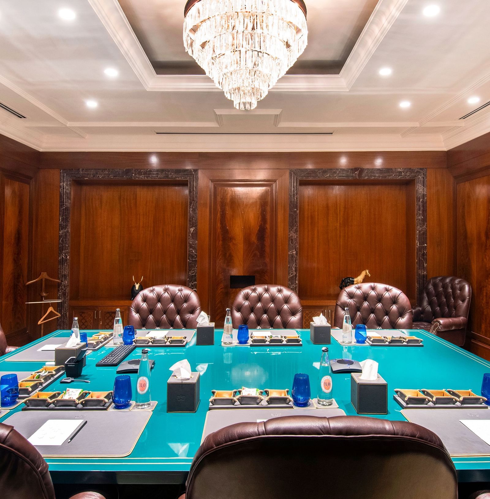 Full view of the Senate Boardroom at The Claridges New Delhi, featuring a wall-mounted TV screen at the far end