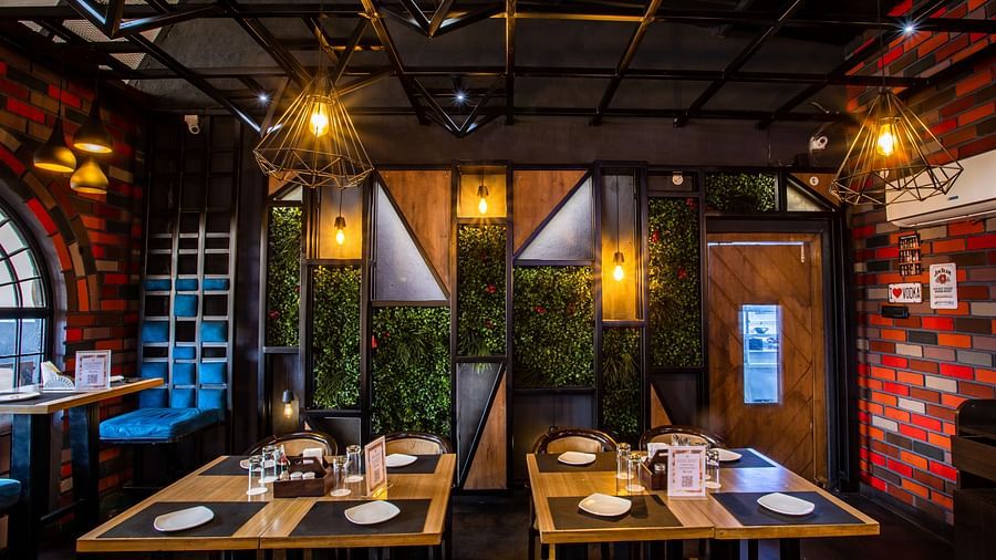 seating arrangements inside a restaurant - Wedlock Greens Hotel Resorts Dhanbad