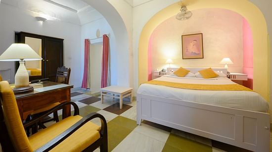 Hill Fort Kesroli 14th Century Alwar - interior view of the Raunak Mahal - Village View room with a queen size bed, a chair and a lamp