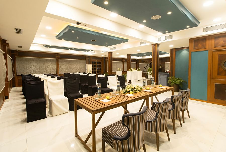 Compass  - Modern conference room in  Polo Floatel Kolkata with black chairs and a stylish wooden table.