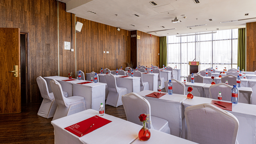 An overview of a meeting room with many tables and chairs in view - Ramada by Wyndham Addis, Addis Ababa.