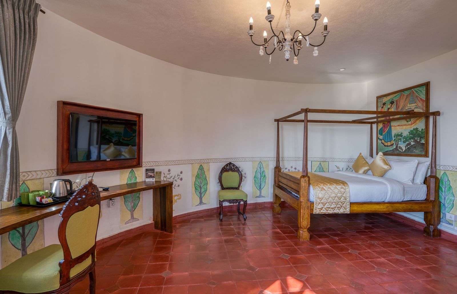 Spacious hotel room with a four-poster bed, chandelier, desk, and rustic decor. | Mango Hill, Yercaud