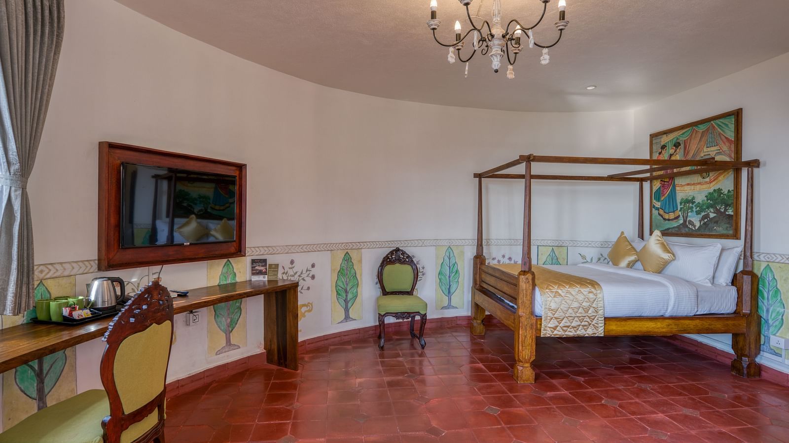 Spacious hotel room with a four-poster bed, chandelier, desk, and rustic decor. | Mango Hill, Yercaud