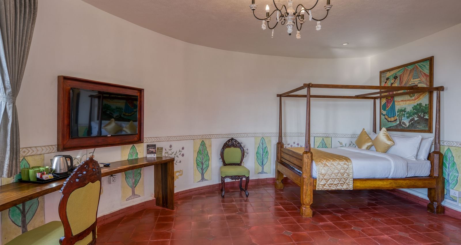 Spacious hotel room with a four-poster bed, chandelier, desk, and rustic decor. | Mango Hill, Yercaud