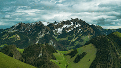 image of a mountain peak touching the clouds in the sky