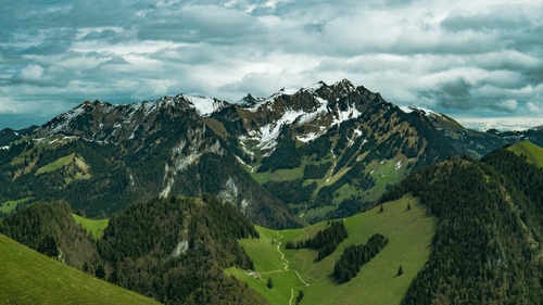 image of a mountain peak touching the clouds in the sky