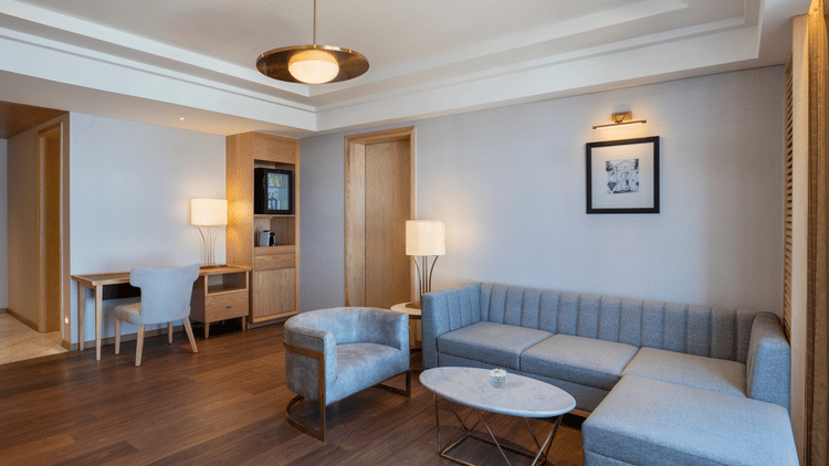 Sitting area at The Residency Towers Puducherry with couches and artworks on the wall.