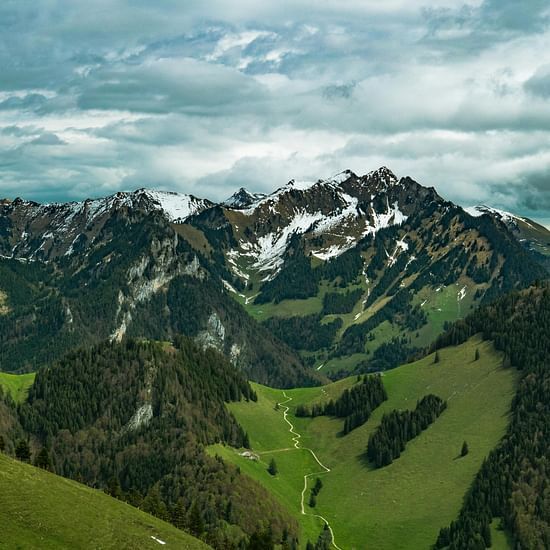 image of a mountain peak touching the clouds in the sky