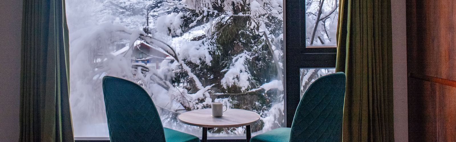 a view of the chairs in a room with a balcony at Mystique Valley Resort  