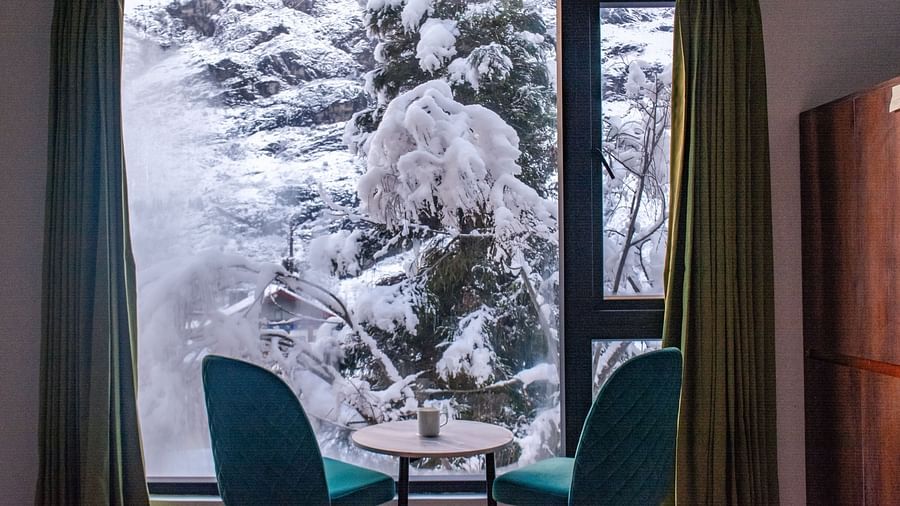 a view of the chairs in a room with a balcony at Mystique Valley Resort  