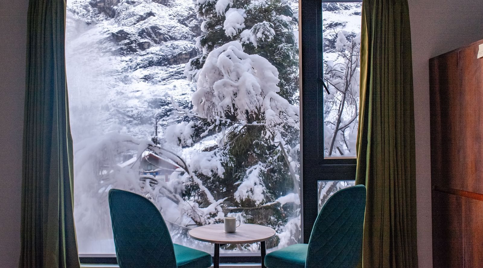 a view of the chairs in a room with a balcony at Mystique Valley Resort  