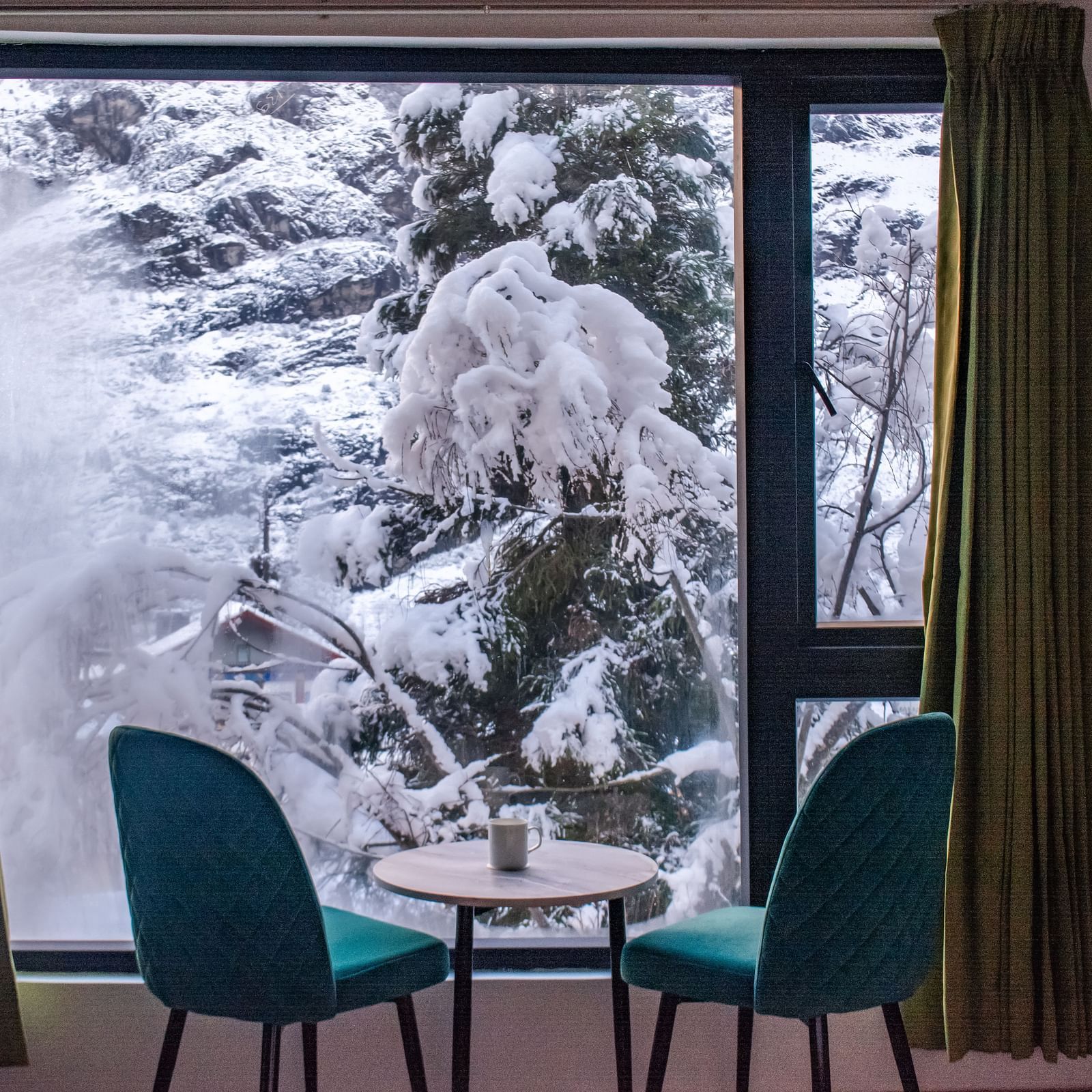 a view of the chairs in a room with a balcony at Mystique Valley Resort  