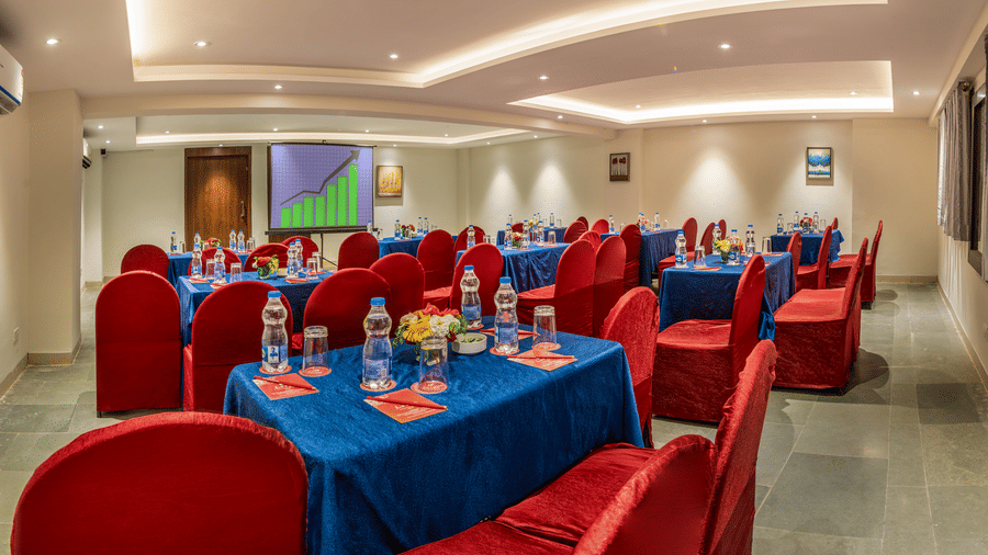  Lords Eco Inn conference area with tables covered in cloths and chairs.