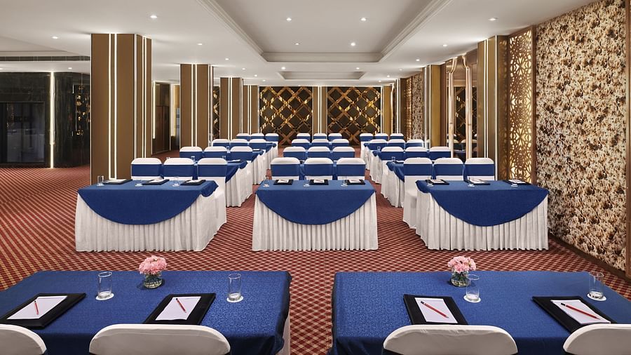 A banquet hall in New Delhi with ambient lighting and comfortable seating - Deventure Sarovar Portico, Patel Nagar