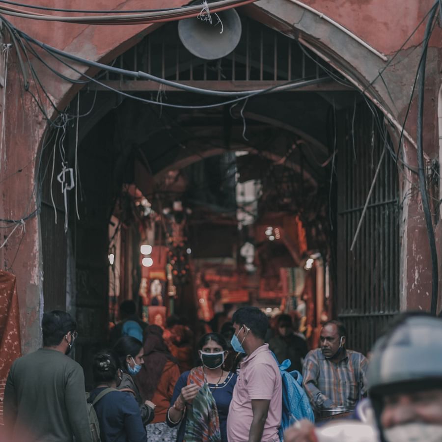a lane filled with people going from under a fort 