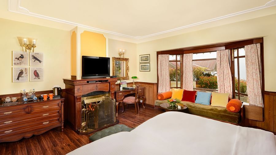 twin beds facing the TV and a cabinet  - Mayfair Hill Resort, Darjeeling 2
