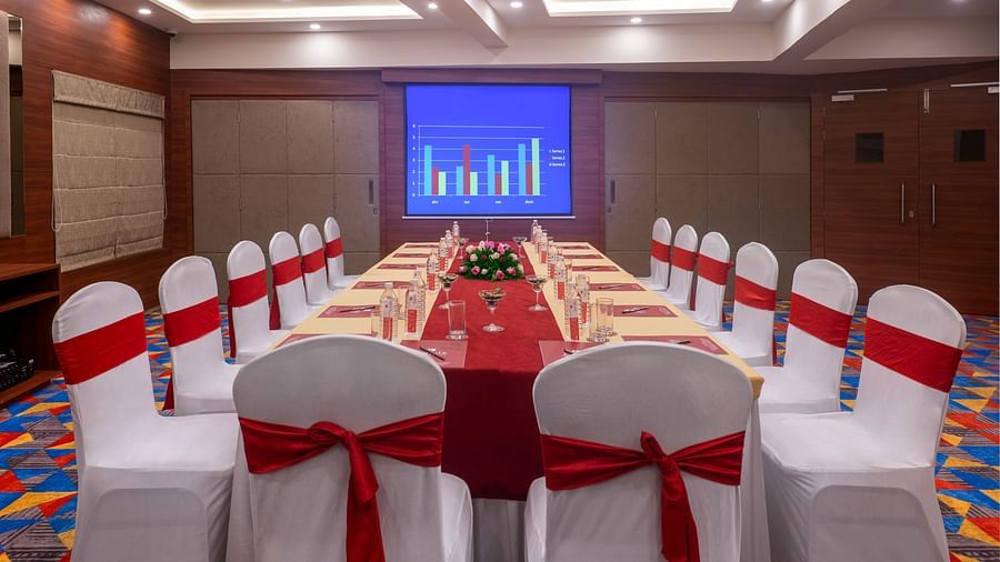 Boardroom arrangement for formal business meetings with screen and ample seating - Lords Eco Inn Shapar Rajkot