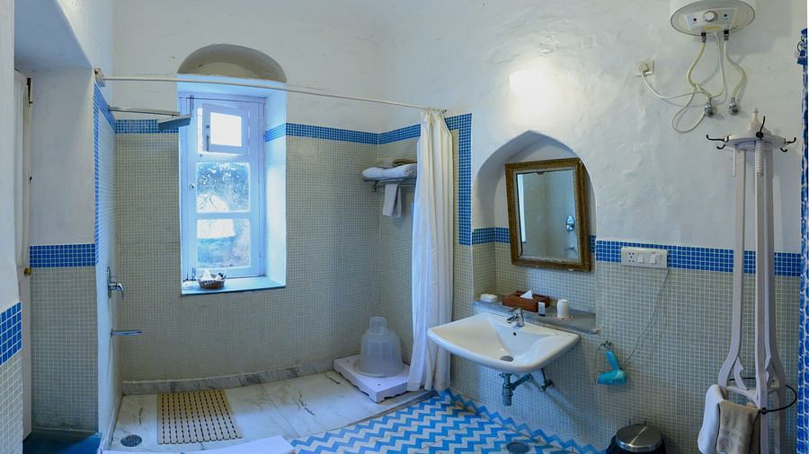 Hill Fort Kesroli 14th Century Alwar - interior view of the Neelkanth Bathroom featuring a shower area, mirror and a wash basin