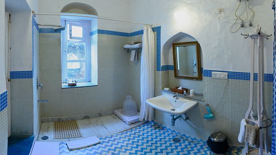 Hill Fort Kesroli 14th Century Alwar - interior view of the Neelkanth Bathroom featuring a shower area, mirror and a wash basin
