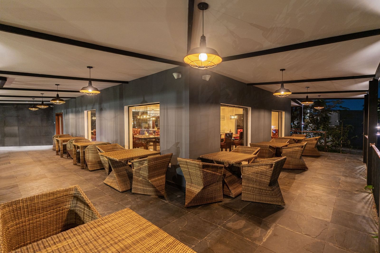 corner view panoramic image of the mekong restaurant with well lit outdoor seating area - Darza Resorts