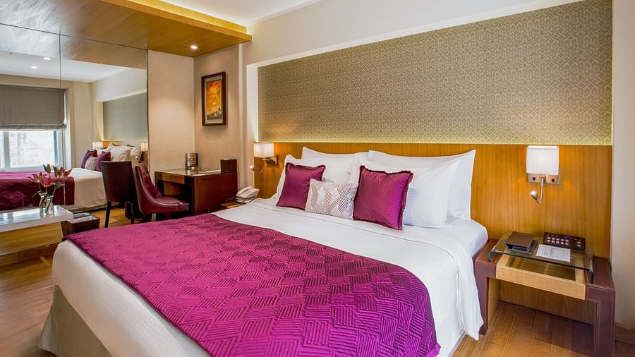 room with king size bed and wooden flooring at hotel bawa continental