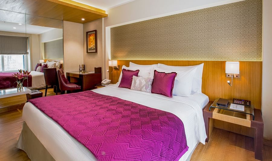 room with king size bed and wooden flooring at hotel bawa continental