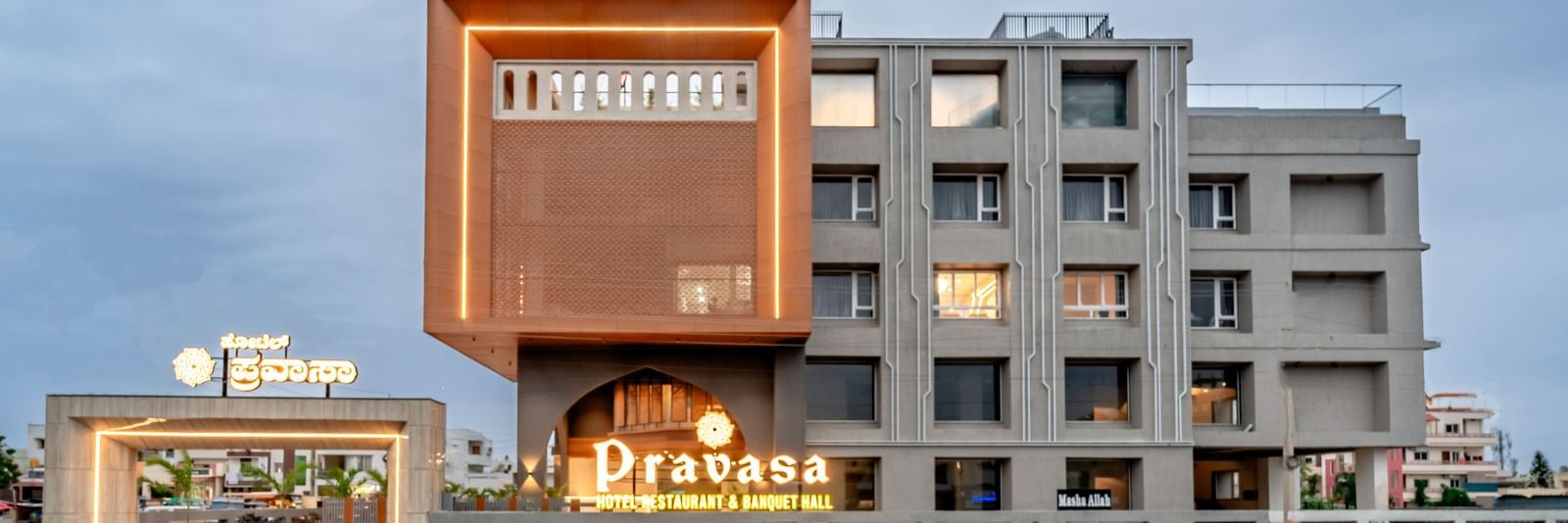Street-level view of Pravasa Hotel entrance with modern architecture | Pravasa Hotel, Vijayapura