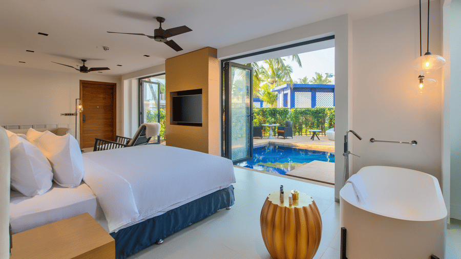 Bedroom in one of the villas in South Goa with private pool at Azaya Beach Resort Goa, overlooking the water.