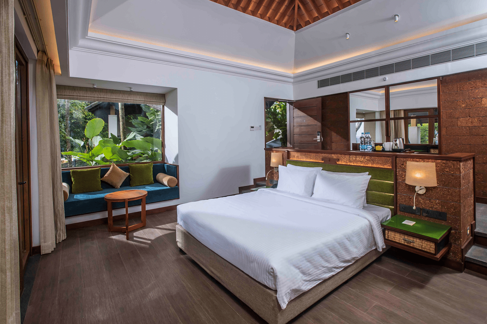 Image of the bed at the bungalow of our hotel | Great Trails Wayanad by  GRT hotels.