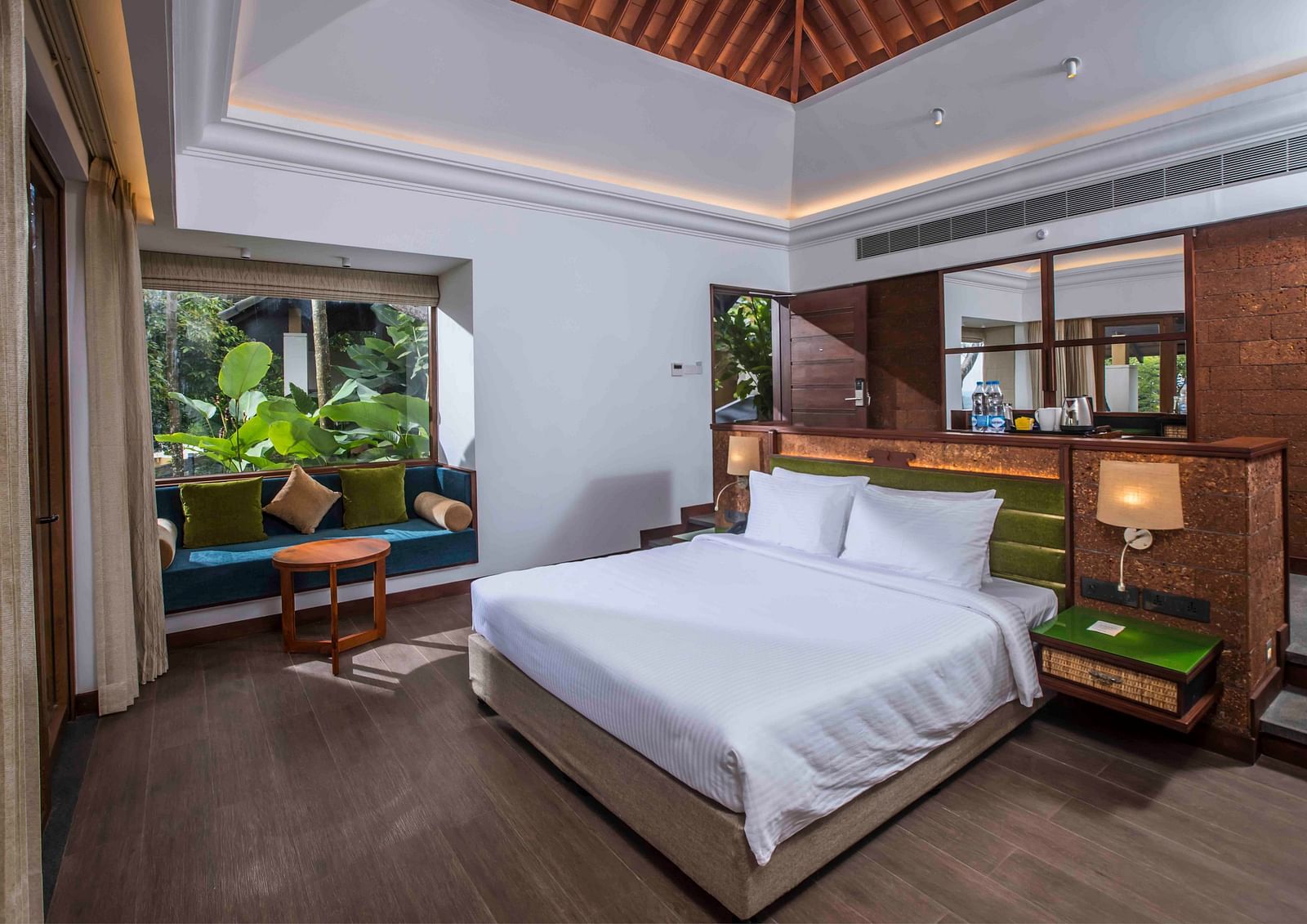 Image of the bed at the bungalow of our hotel | Great Trails Wayanad by  GRT hotels.
