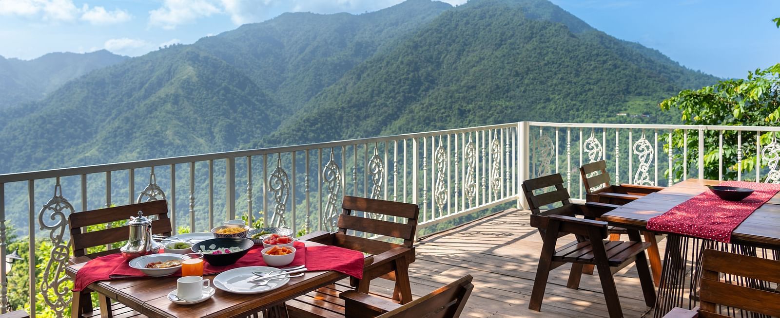 alfresco seating area with mountain view in the background - neer ganga resorts