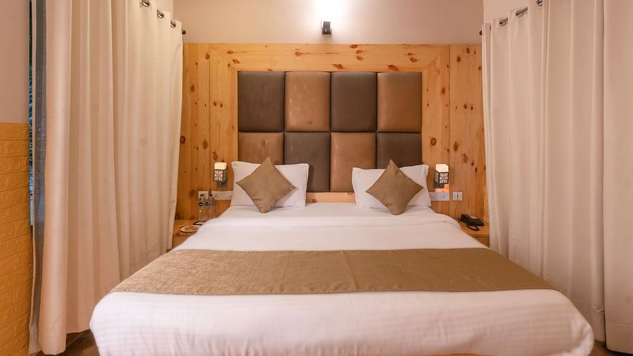Comfortable king-bed guest room at The Tattwaa Corbett Spa & Resort.