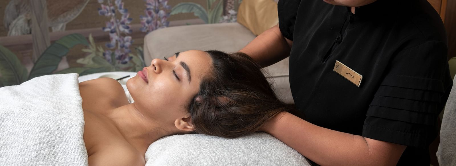 A woman recieving a head massage from a masseuse in Cinqtuair Spa - Claridges Collection