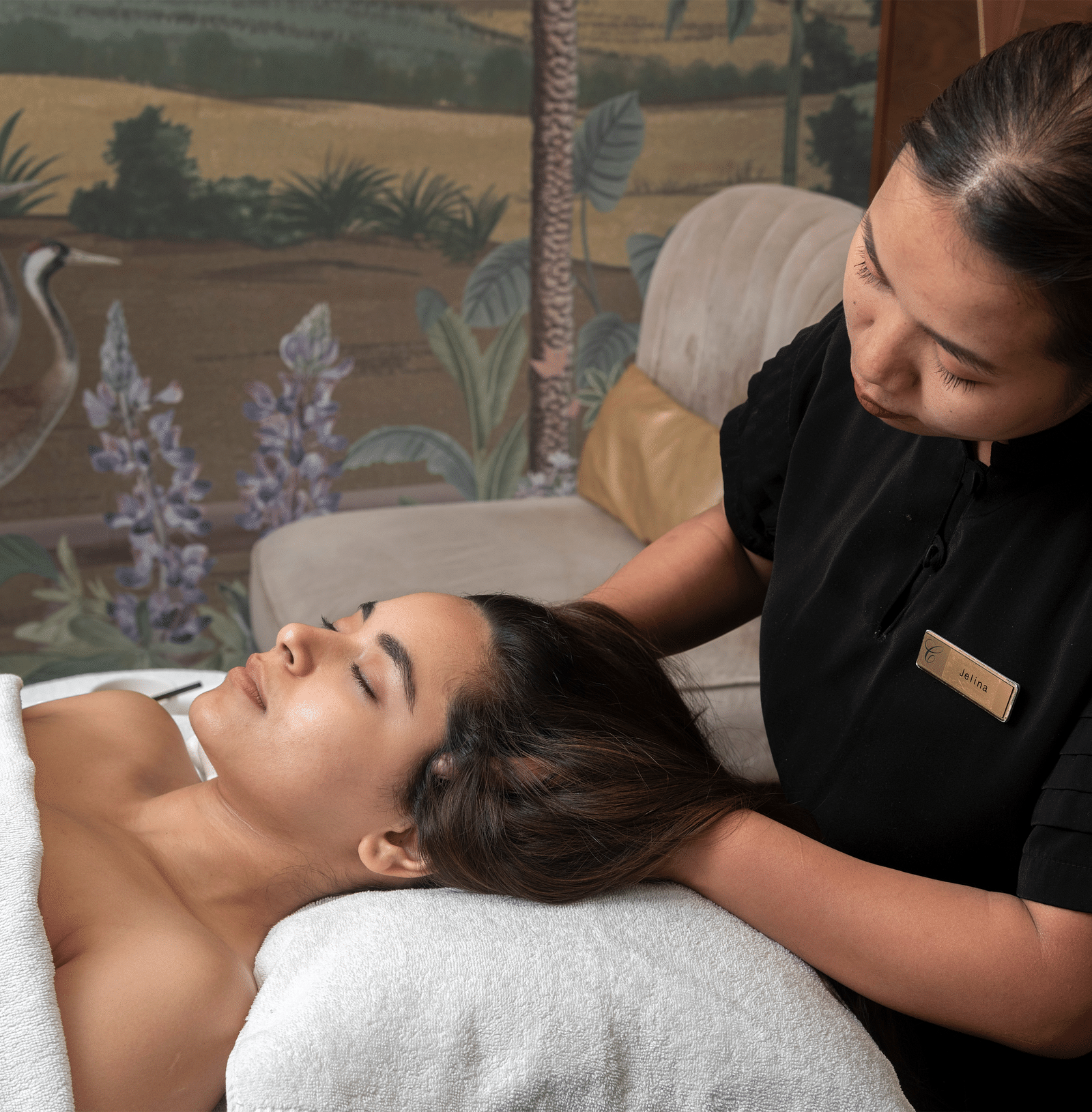 A woman recieving a head massage from a masseuse in Cinqtuair Spa - Claridges Collection