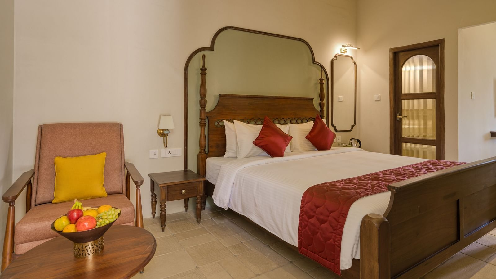 A double bed with a sofa next to it inside the studio | Mango Hill Shola Ooty