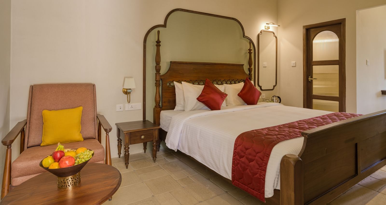 A double bed with a sofa next to it inside the studio | Mango Hill Shola Ooty