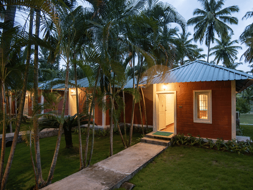 entrance to a villa with stone pavement and grass on either side