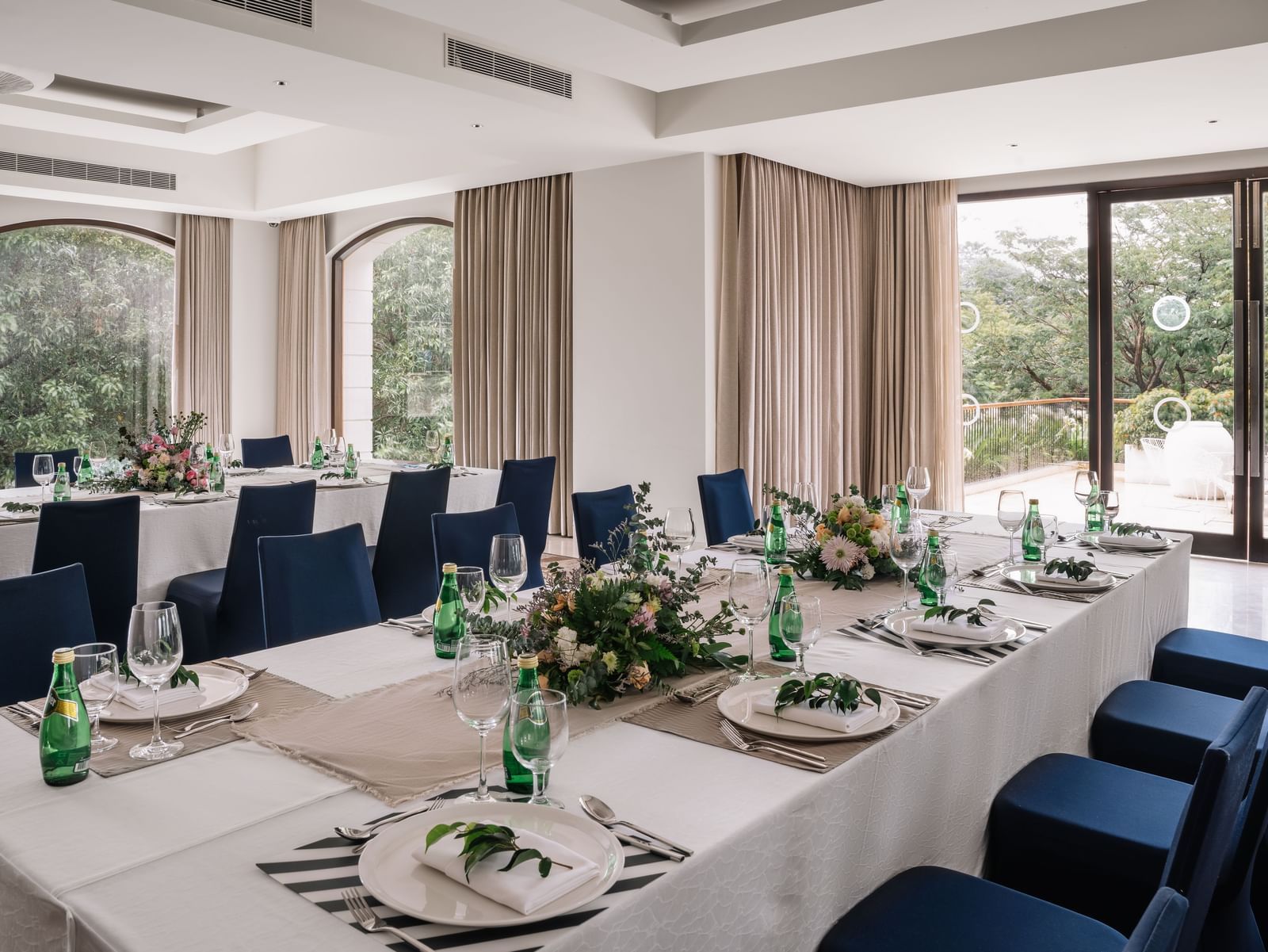 An elegant dining setup in a spacious banquet hall at The Raintree, St. Mary's Road, perfect for events and gatherings.