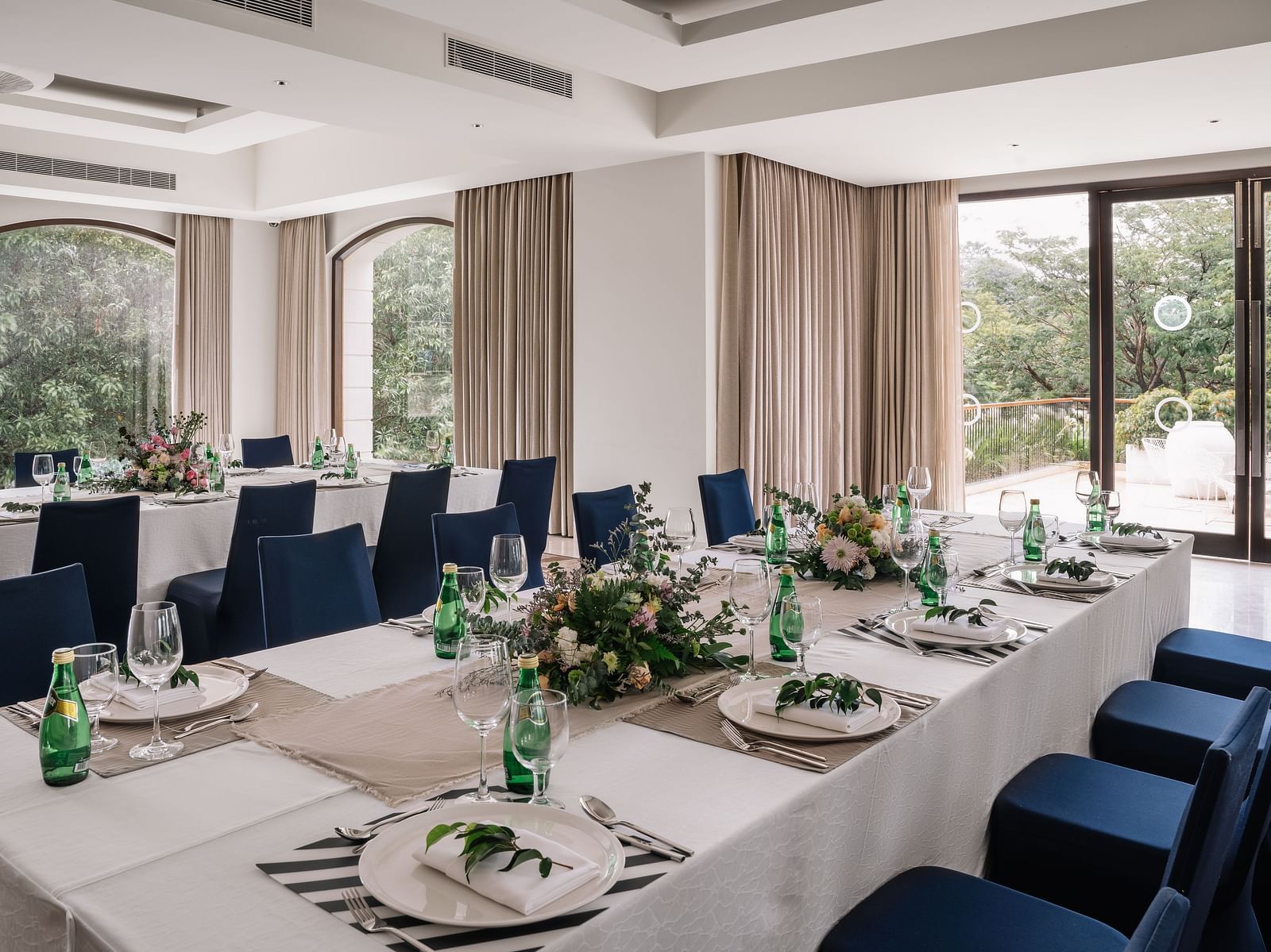 An elegant dining setup in a spacious banquet hall at The Raintree, St. Mary's Road, perfect for events and gatherings.