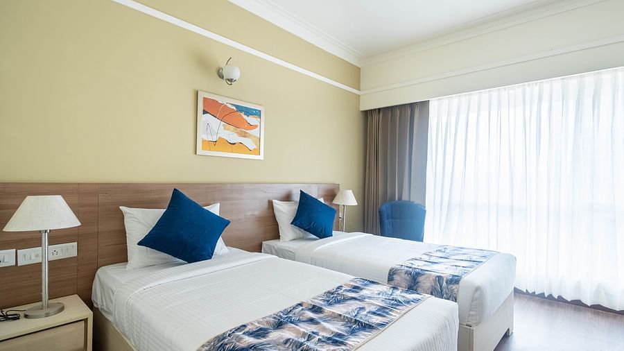 twin beds inside Deluxe One Bedroom Suite 3 - Starlit Suites Newtown, Kolkata