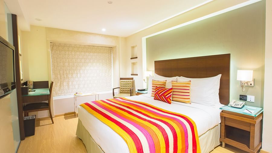 room with king size bed and wooden furnishing at hotel bawa continental