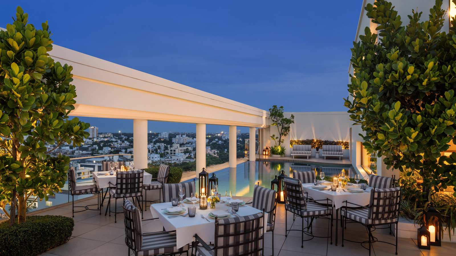 Rooftop dining area with tables, chairs, and plants at The Raintree, St. Mary’s Road.